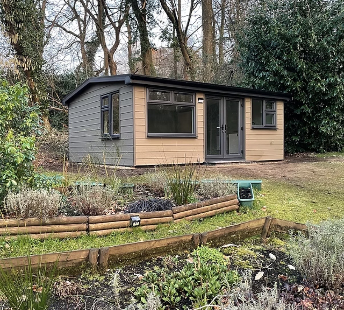 Two-tone timber garden room built in a wooded Surrey garden
